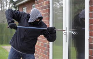 Door being forced open by burglar